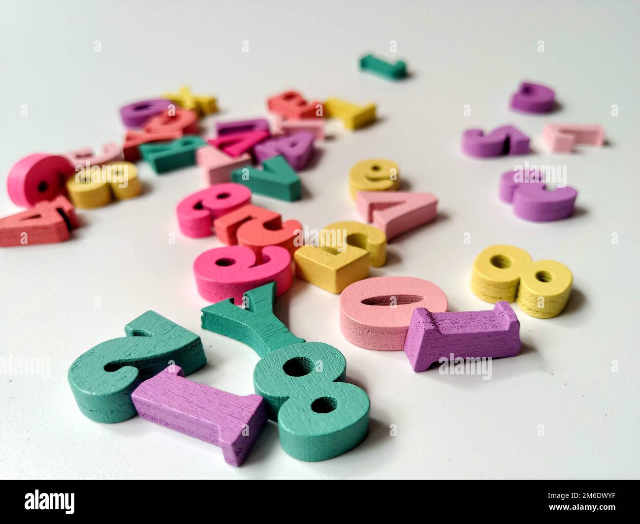 Children's colored letters placed on a white background. Stock Photo