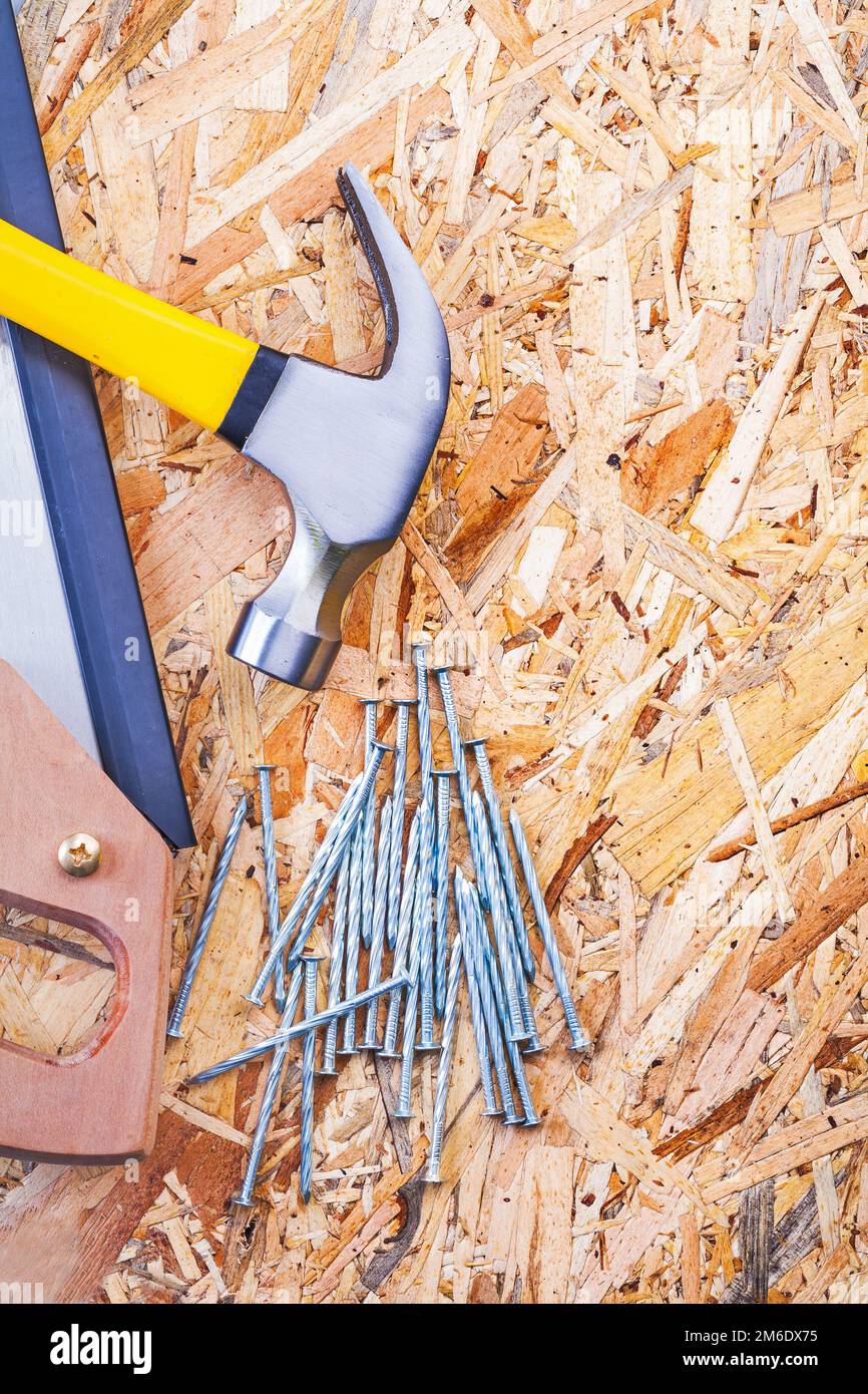 handsaw claw hammer and nails on plywood Stock Photo Alamy