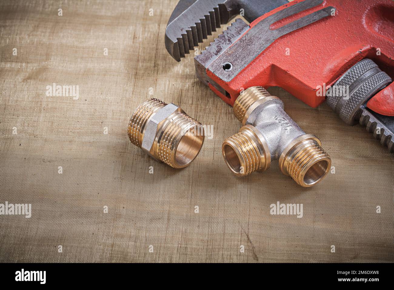 Plumbers wrench plumbing fixtures on mesh filter grid Stock Photo - Alamy