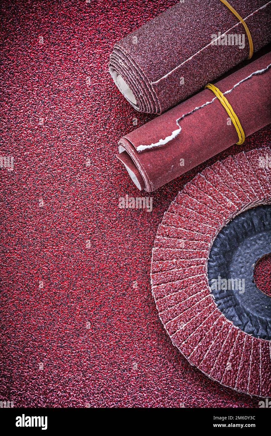 Rolled emery paper flap grinding wheel on abrasive sheet Stock Photo