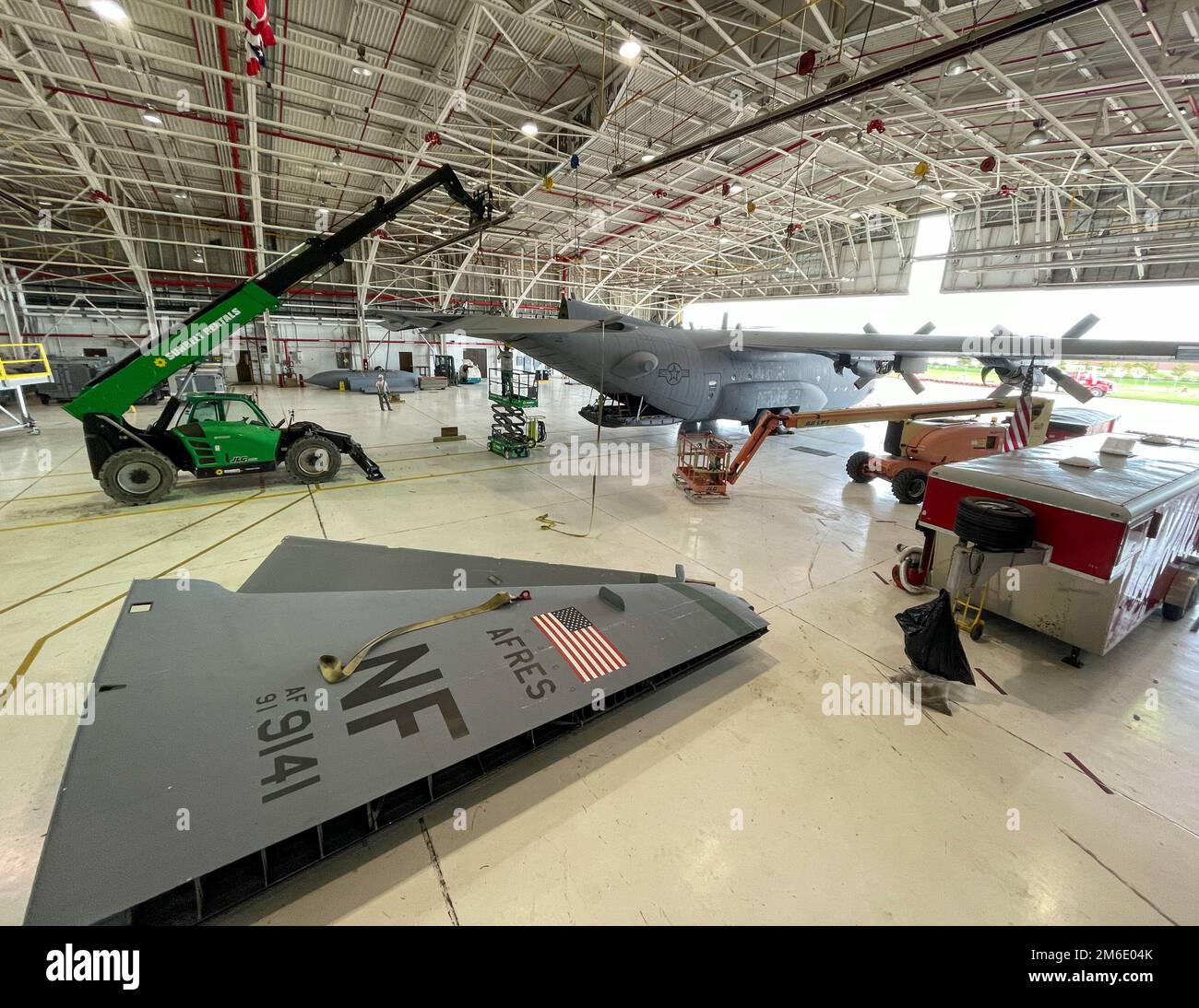 The tail and rudder of a C-130H Hercules transport plane lies on the hangar floor while the tail section is being removed April 25, 2022 at Niagara Falls Air Reserve Station, New York. Other main parts such as the tail and wings will be removed in order, so the plane may be transported to its static display location on base. Stock Photo