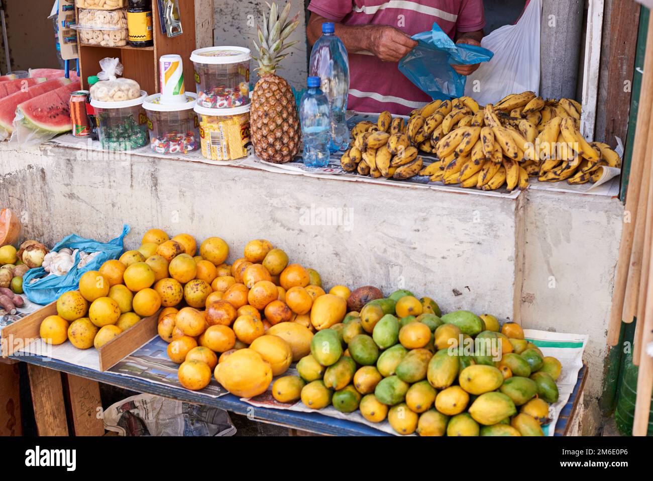 Fruit and snacks for sale. a street vendor selling food at his market ...