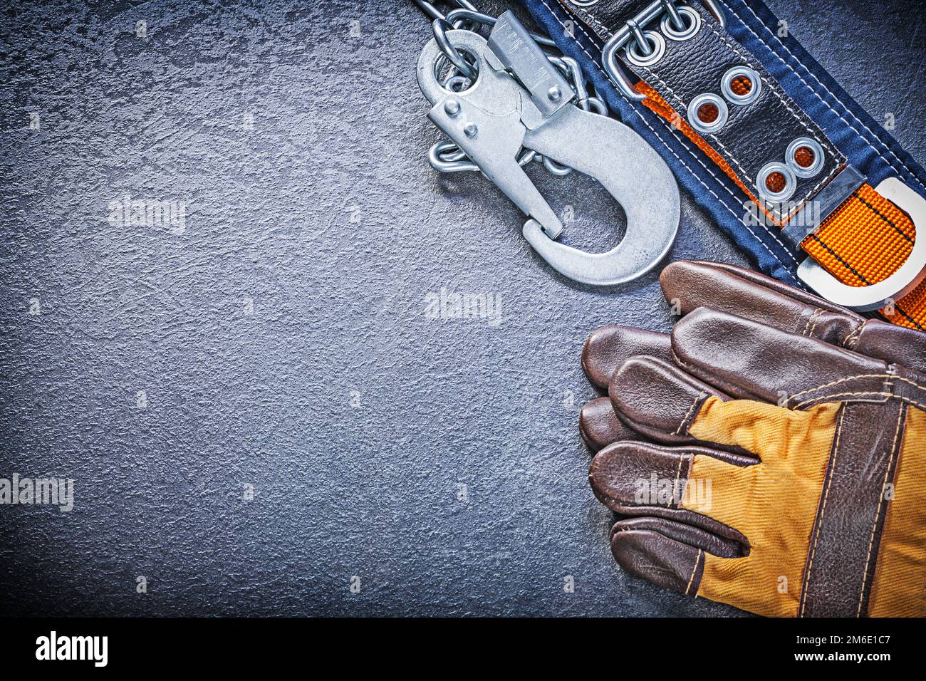 Construction body belt protective gloves on black background maintenance concept. Stock Photo