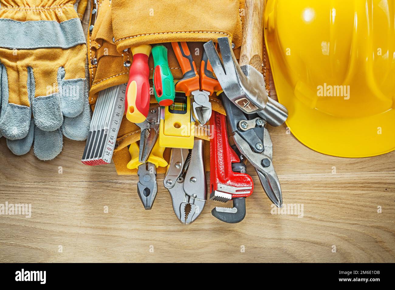 Construction tooling tool belt safety gloves hard hat. Stock Photo