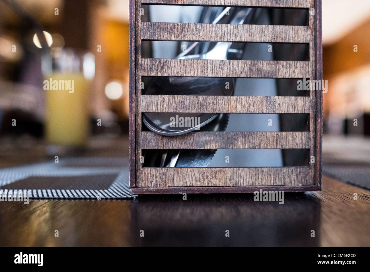 Wooden cutlery stand in a cafe. Spoon, fork for lunch in a restaurant