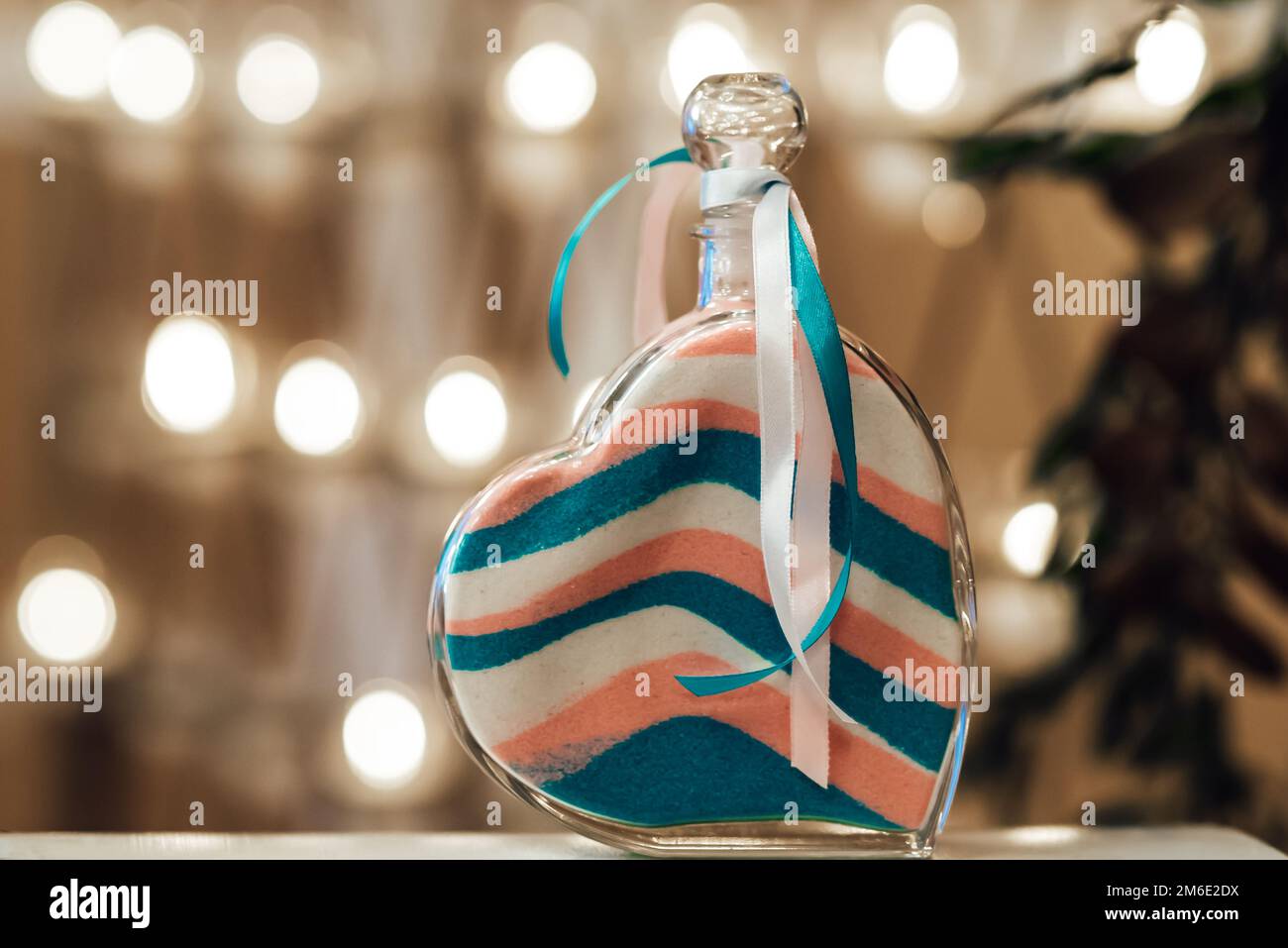 sand wedding ceremony, colored sand layers in a vessel in a heart whit