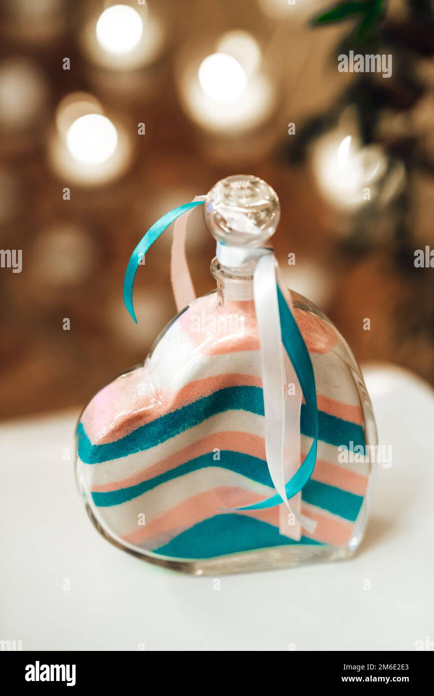 sand wedding ceremony, colored sand layers in a vessel in a heart whit