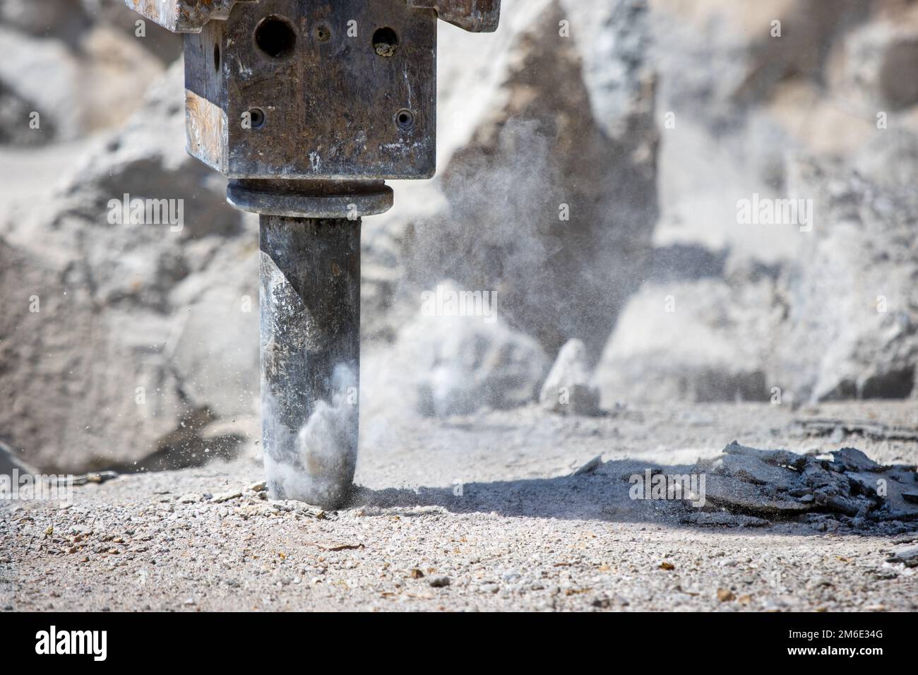 Jackhammer hammering concrete for hole and making dust Stock Photo Alamy