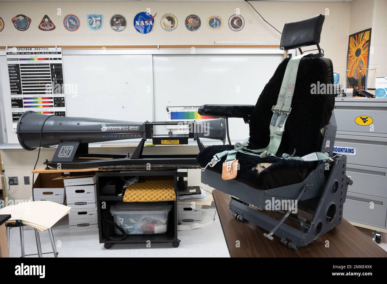 A aircraft seat from a C130 E model sits on display in a classroom at