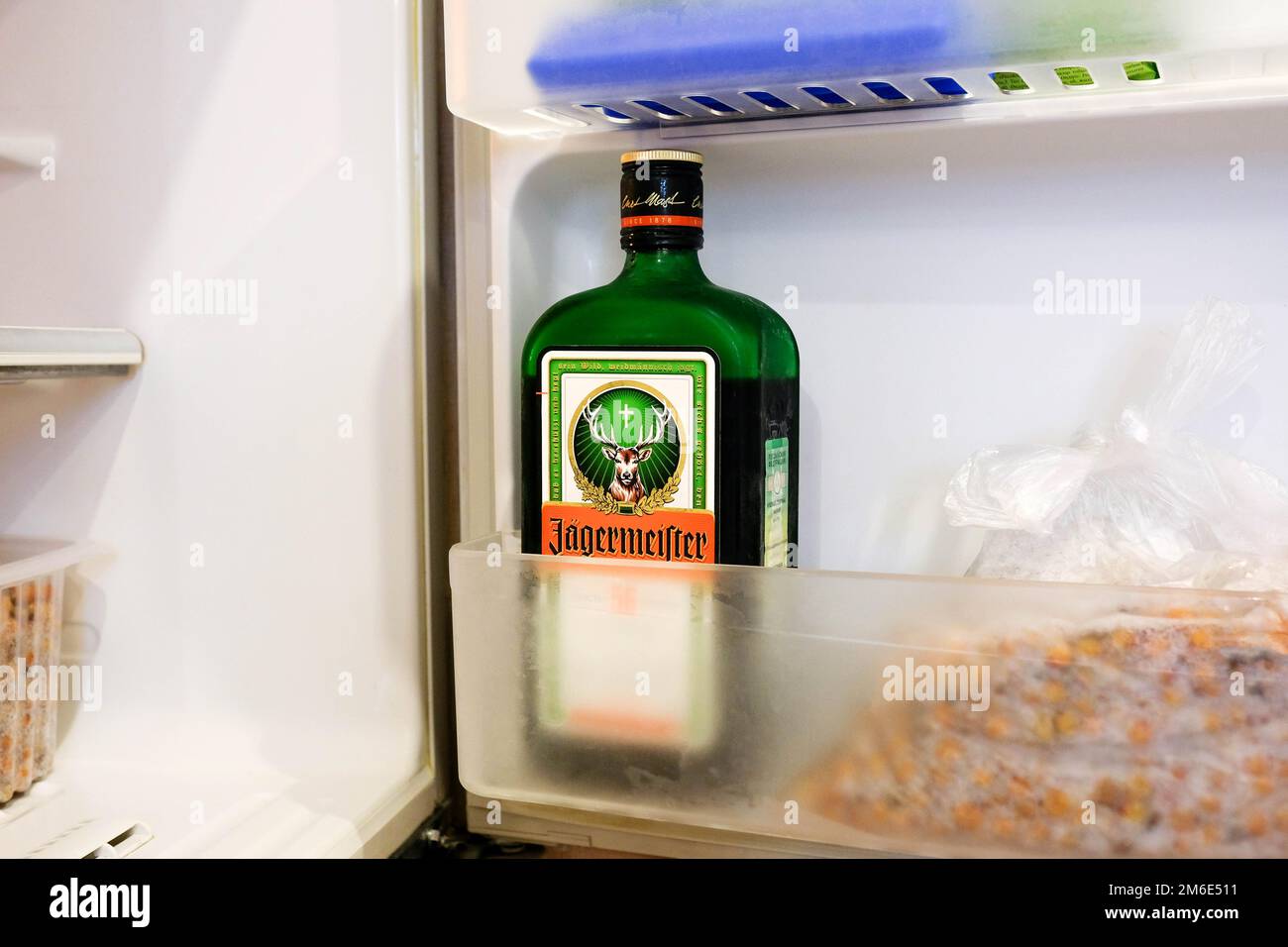 Jagermeister in the freezer. Storage of liquor in the refrigerator at home Stock Photo