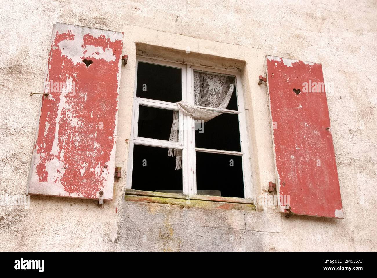 An old window with shutters where the paint is peeling Stock Photo - Alamy