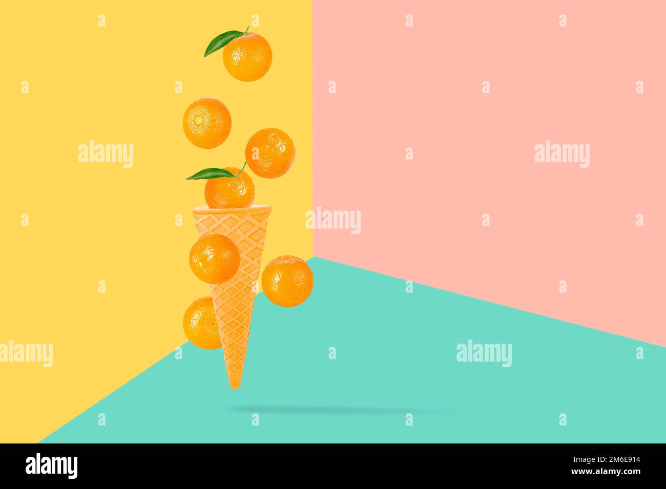 Falling ice cream cone with mandarin fruits. Seven flying whole