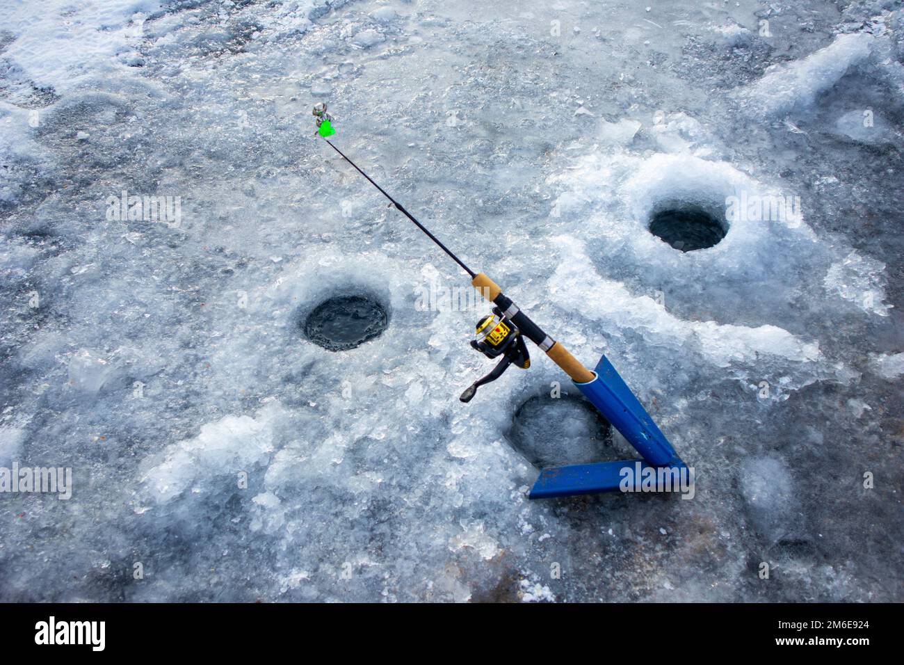 fishing rod and hole. winter fishing Stock Photo - Alamy