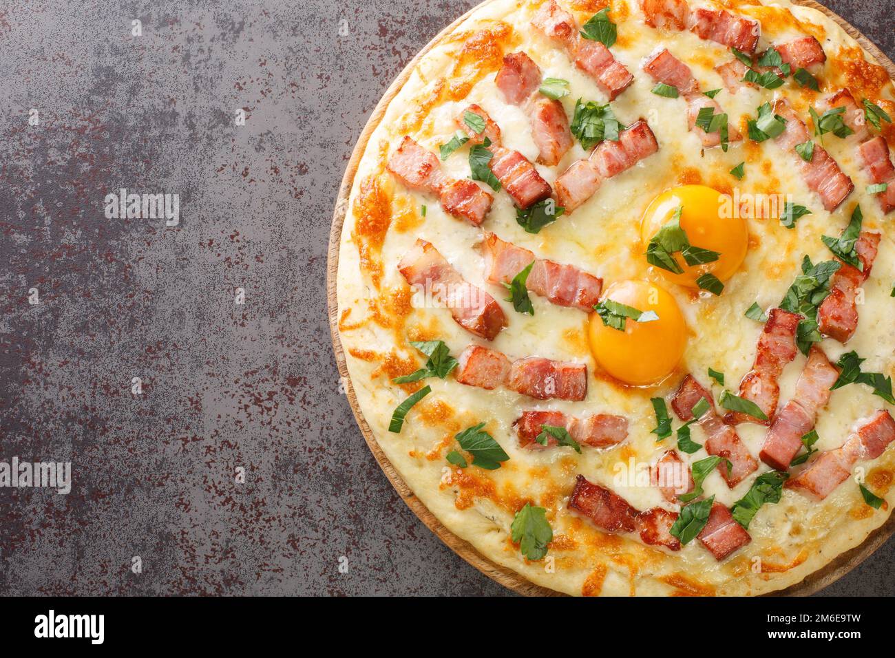 traditional pizza carbonara with egg, cream, smoked bacon, parmesan and