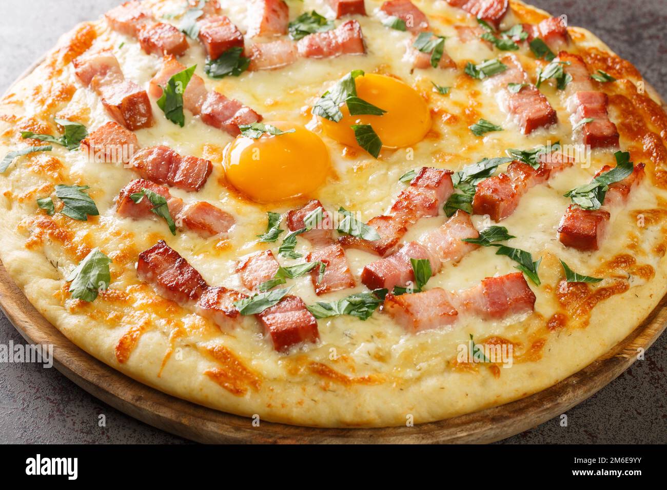 traditional pizza carbonara with egg, cream, smoked bacon, parmesan and