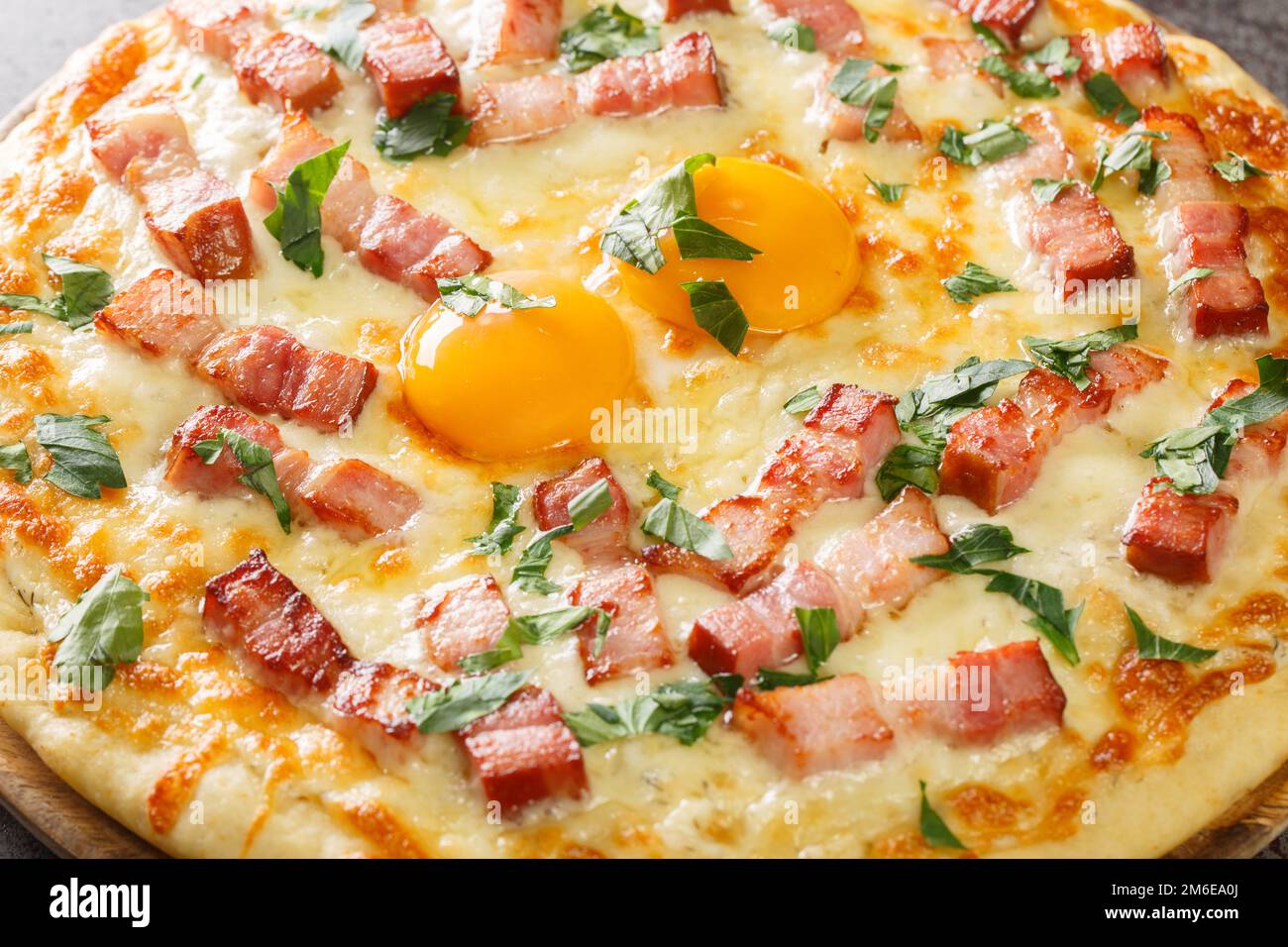 Italian Pizza carbonara Contains egg yolk, cream, bacon, parmesan and Mozzarella cheese closeup