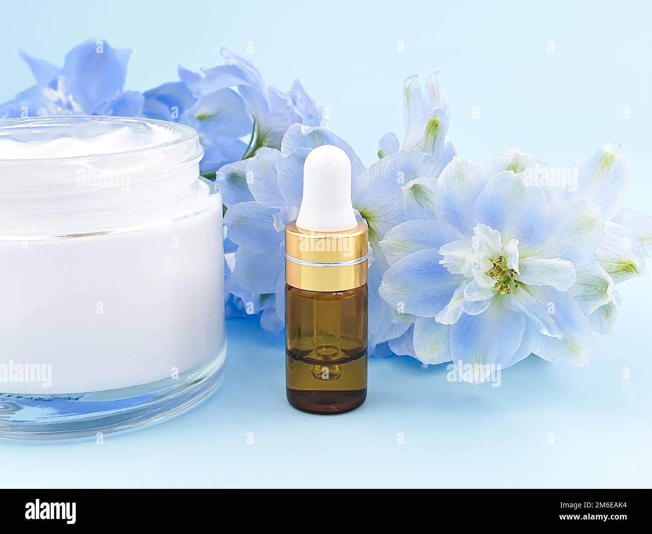 Serum in gold glass bottle with pipette or essential oil, moisturizer