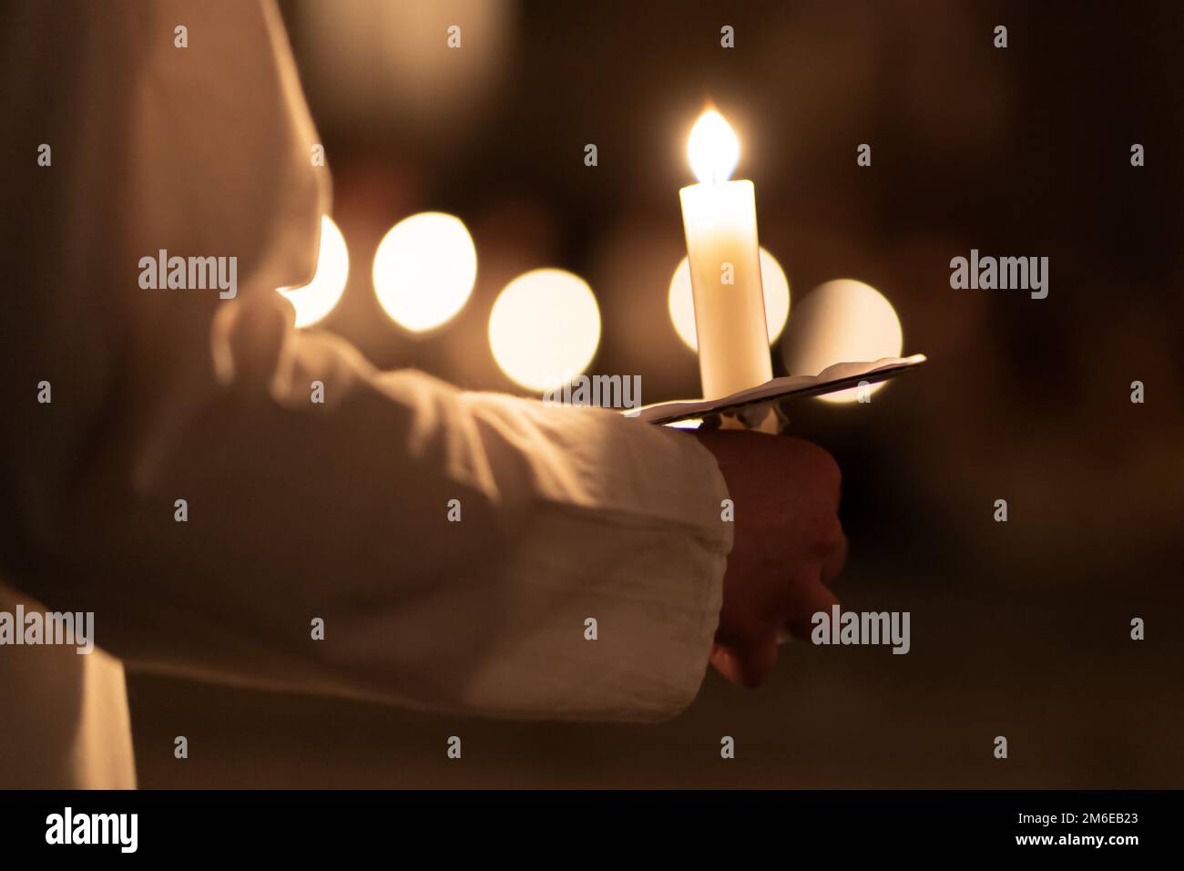 People handling candles in the hands. Christmas and lucia holidays Stock Photo