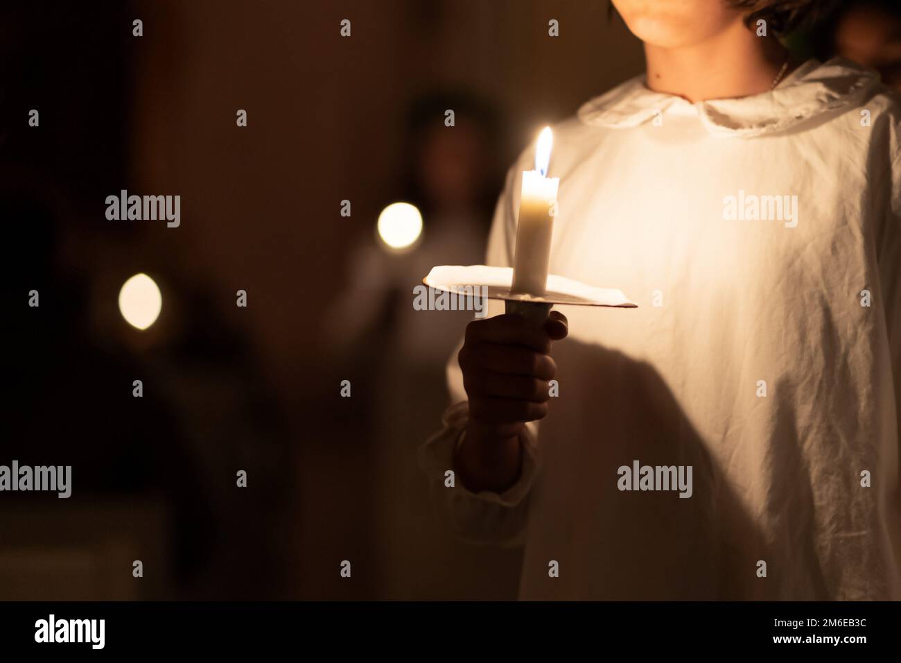 People handling candles in the hands. Christmas and lucia holidays Stock Photo