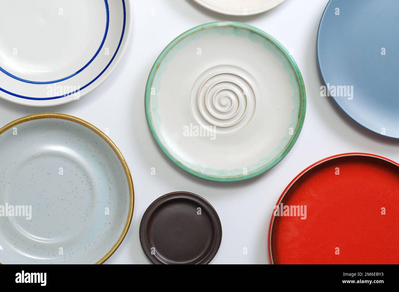 Various empty plates on white table, top view Stock Photo