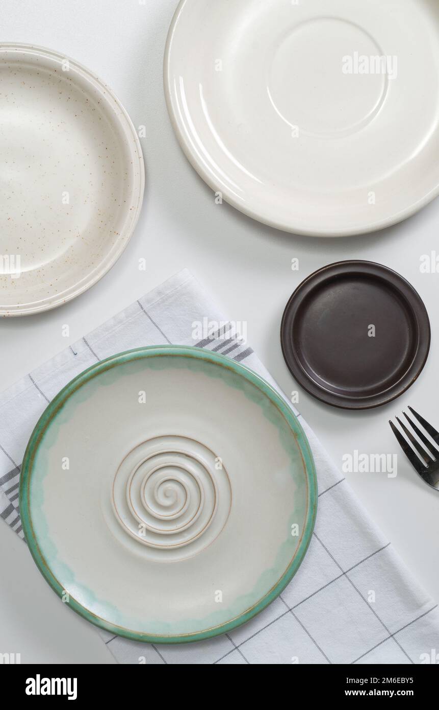 Various empty plates on white table, top view Stock Photo