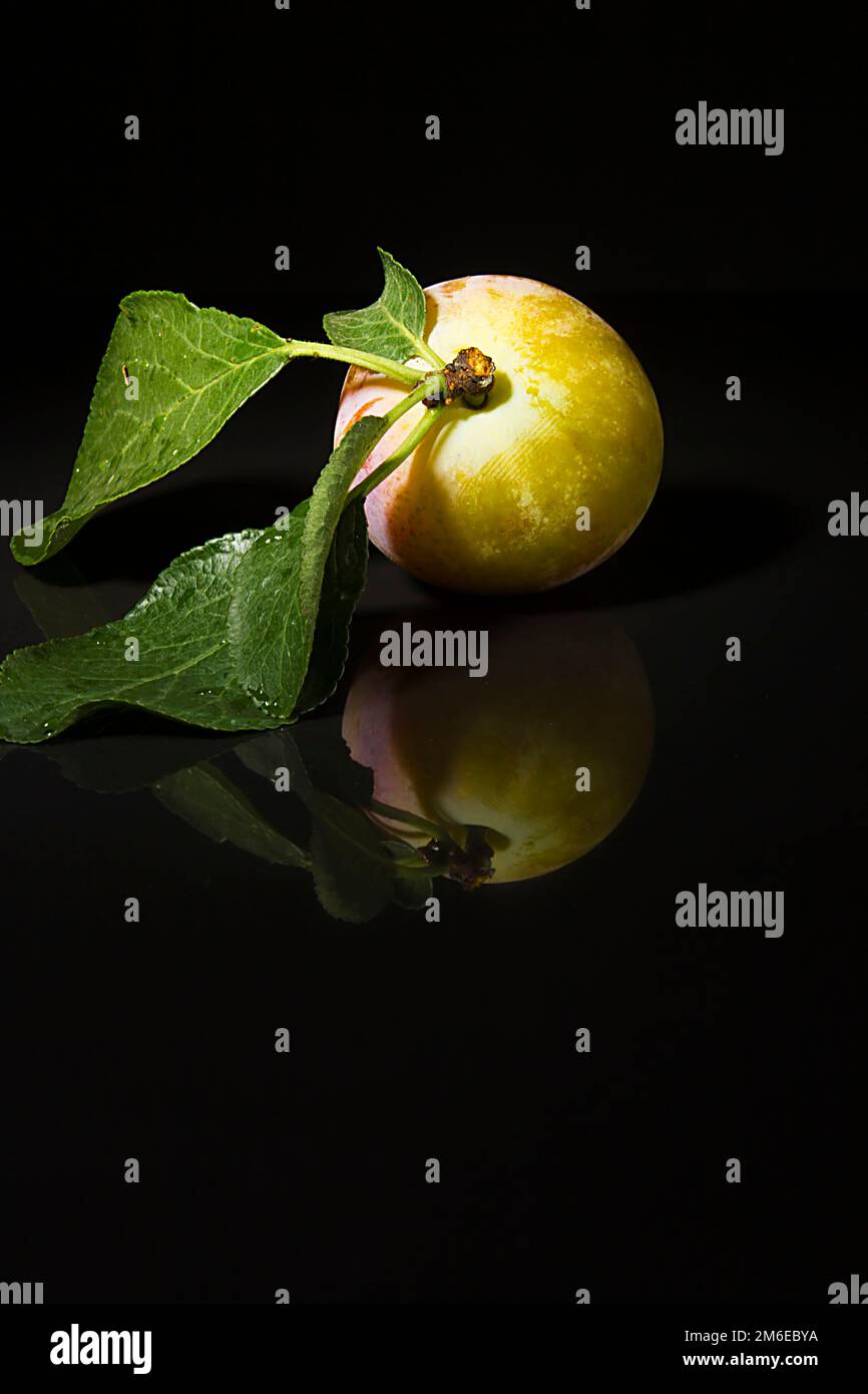 Ripe plums on a black background Stock Photo