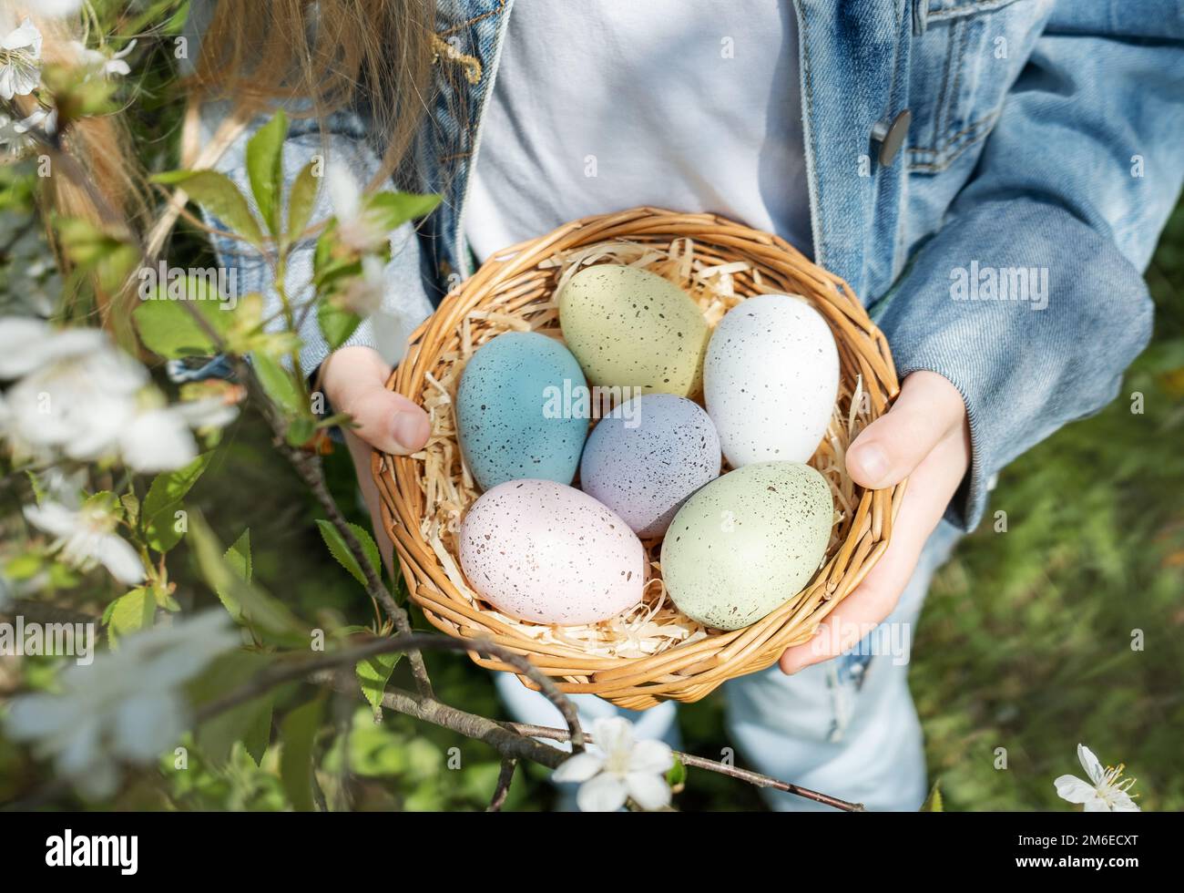 Cute little child wearing bunny ears on Easter day. Girl holding basket ...