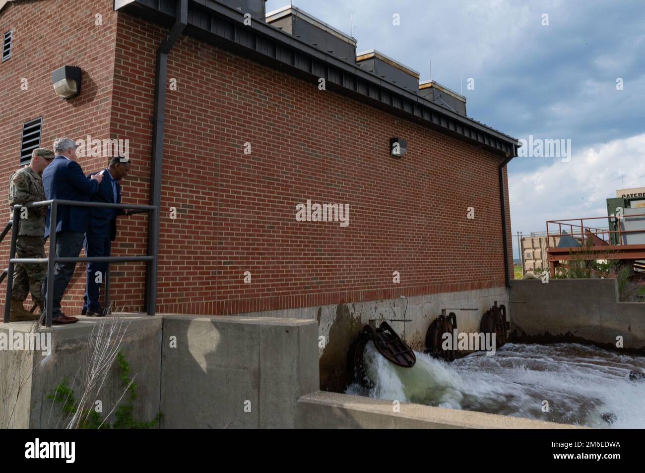 Officials from the Virginia Department of Veterans and Defense Affairs view a demonstration of the water pumping station at Joint Base Langley-Eustis, Virginia, April 26, 2022. The water pumping station displaces approximately 7.4 million gallons of water per hour, allowing for a faster recovery of the air field in the event of inclement weather. Stock Photo