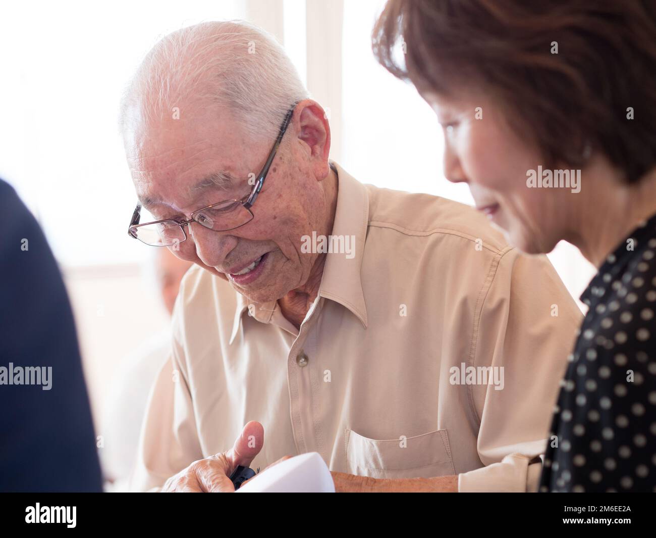 An elderly man looking at something he is receiving with great interest Stock Photo