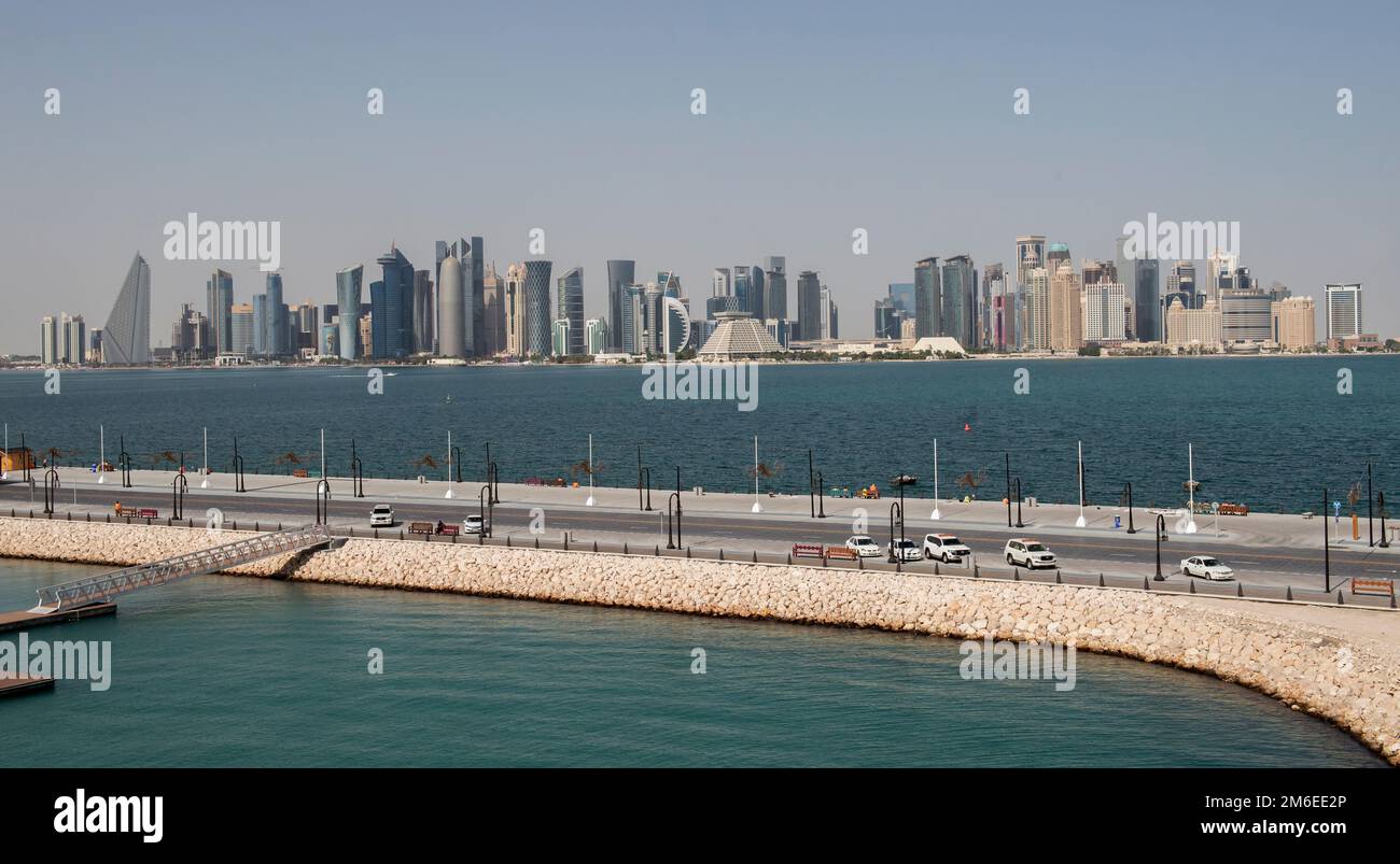 Buildings on the waterfront in Doha, Qatar, including the Tornado Tower, also called the QIPCO Tower, the Burj Doha (Doha Tower), the Pyramid Shaped S Stock Photo