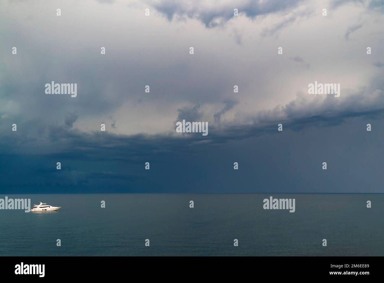 White yacht in the sea before the storm clouds Stock Photo Alamy