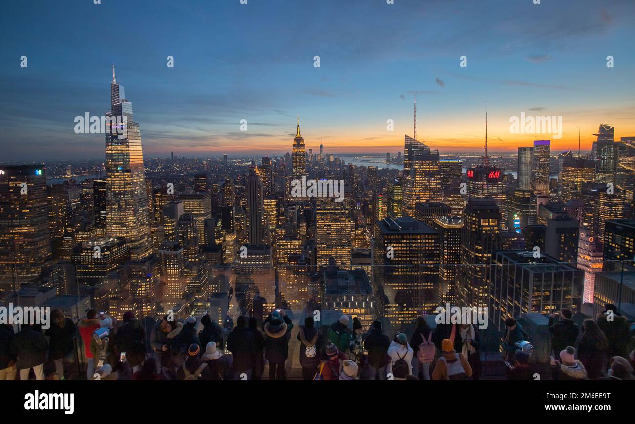 Visitors to the Rockefeller Centre view the New York Skyline including (from left) The Chrysler Building, One Vanderbilt, the second tallest office bu Stock Photo