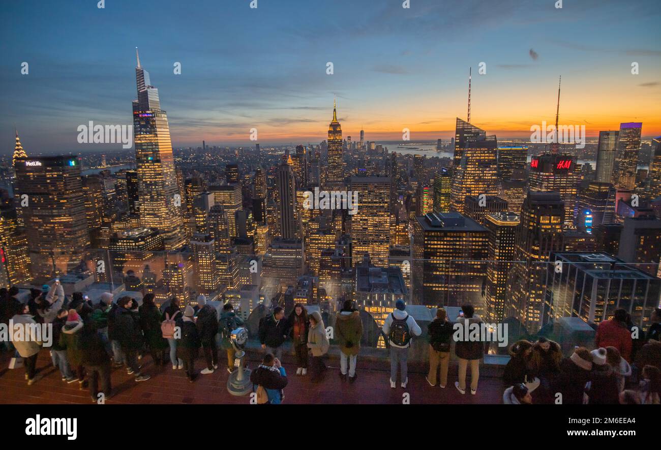 Visitors to the Rockefeller Centre view the New York Skyline including (from left) The Chrysler Building, One Vanderbilt, the second tallest office bu Stock Photo