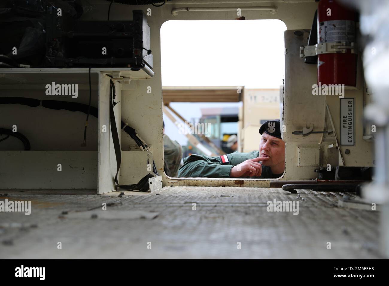 A Polish soldier looks inside an M88 Hercules Recovery Vehicle during a class on sustainment taught by senior noncommissioned officers assigned to 2nd Battalion, 34th Armored Regiment, 1st Armored Brigade Combat Team, 1st Infantry Division, as a part of the Abrams Operations Summit at Drawsko Pomorskie, Poland, April 26, 2022. Working alongside Allies in the European theater remains an integral part of demonstrating alliance readiness, interoperability, and capability. Stock Photo
