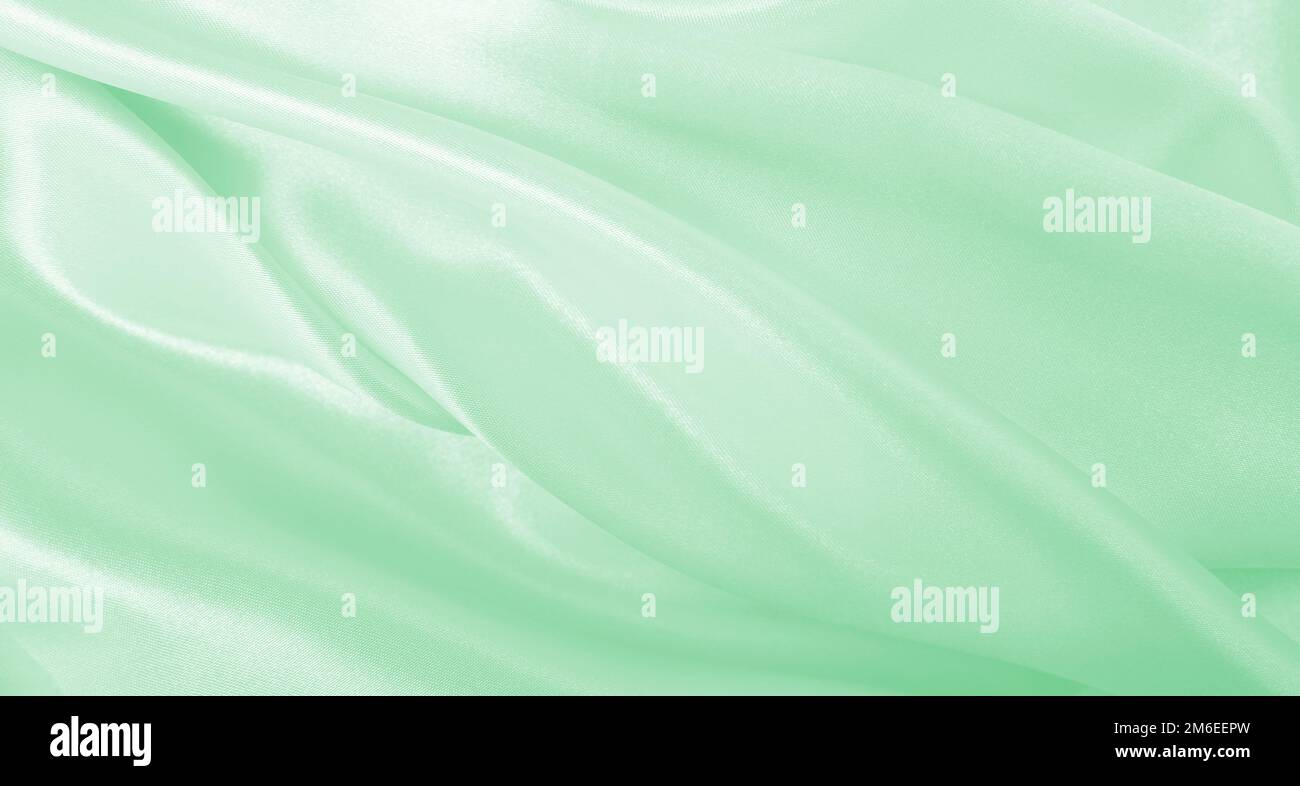 Smooth elegant green silk or satin luxury cloth texture can use as ...