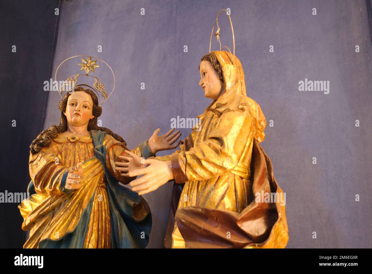 Beautiful wood carved, gold covered, fancy angels with delicate hands and halos. At the Igreja da Misericórdia museum and Catholic church landmark in Stock Photo