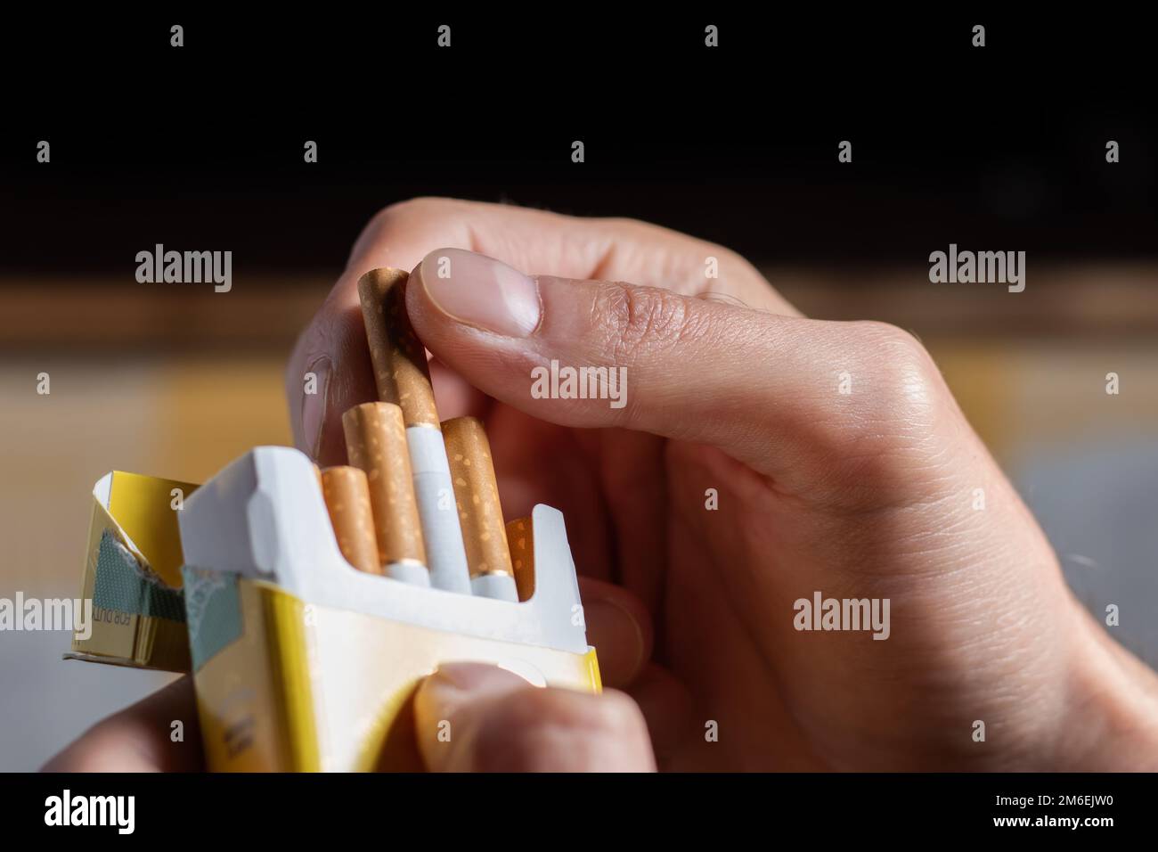 close up man hand holding peel it off cigarette pack prepare smoking a ...