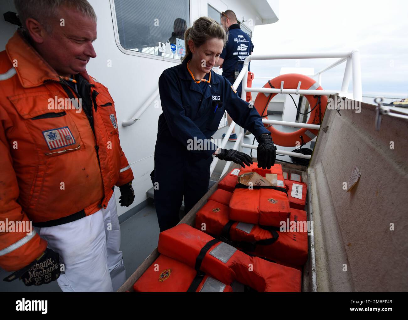 U.S. Coast Guard Chief Warrant Officer and Lt. j.g. Amanda Degener, marine inspectors at Marine Safety Unit (MSU) Cleveland, inspects life jackets during a vessel inspection April 26, 2022, in Cleveland, Ohio. MSU Cleveland conducts vessel inspections to make sure vessels are in compliance safety, security, and environmental regulations. Stock Photo