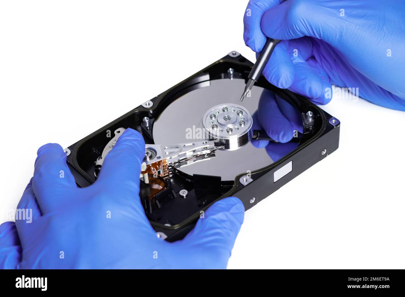Repair Hard disk. Hands of master in gloves with screwdriver