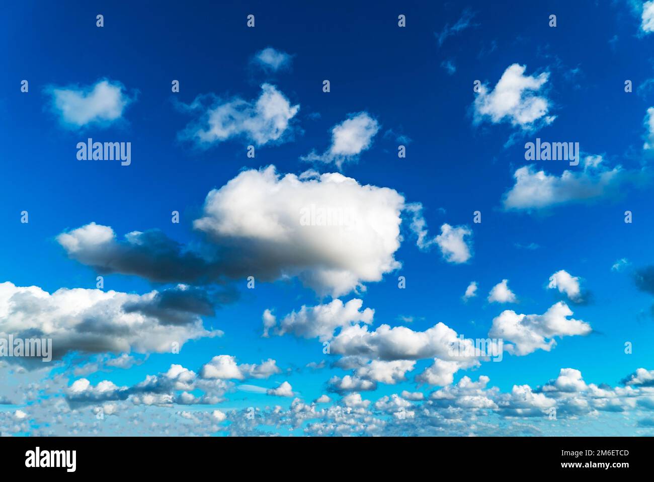 White clouds on a blue sky on a Sunny day. Stock Photo