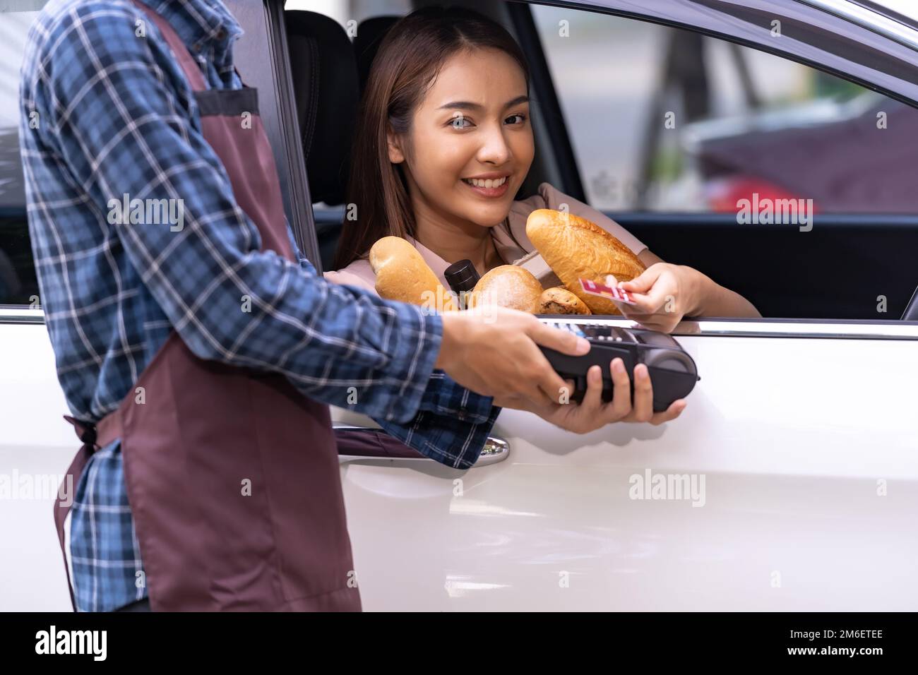 Asian woman making contactless payment for grocery Stock Photo