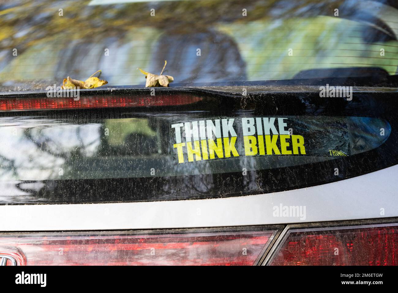 Think Bike Think Biker sticker on car rear windscreen - UK Stock Photo