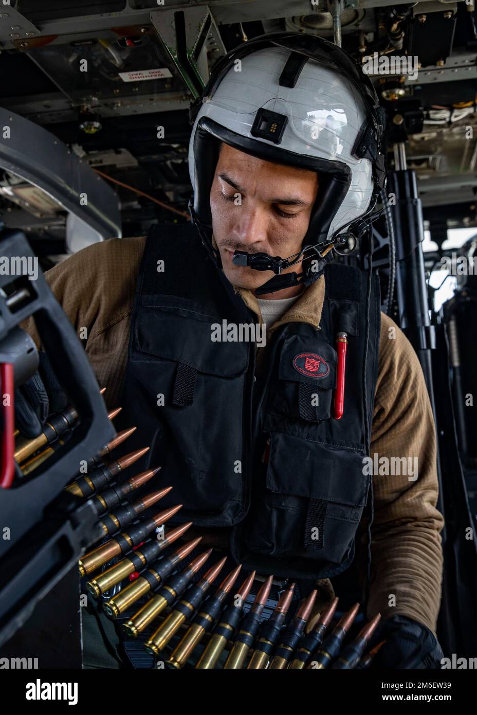 Naval Aircrewman (helicopter) 3rd Class Daniel Brito flies during a gun exercise with Helicopter Sea Combat Squadron (HSC) 5 at Naval Air Station Fallon, April 26, 2022. Carrier Air Wing (CVW) 7 is the offensive air and strike component of Carrier Strike Group (CSG) 10 and the George H.W. Bush CSG. The squadrons of CVW-7 are Strike Fighter Squadron (VFA) 143; VFA-103; VFA-86; VFA-136; Electronic Attack Squadron (VAQ) 140; Carrier Airborne Early Warning Squadron (VAW) 121; HSC-5; and Helicopter Maritime Strike Squadron (HSM) 46. Stock Photo