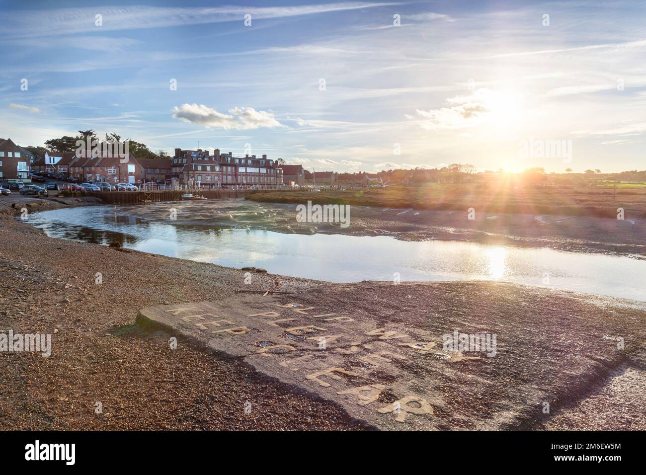 Blakeney hotel and quay harbour tidal channel in Norfolk England at low tide in the evening Stock Photo