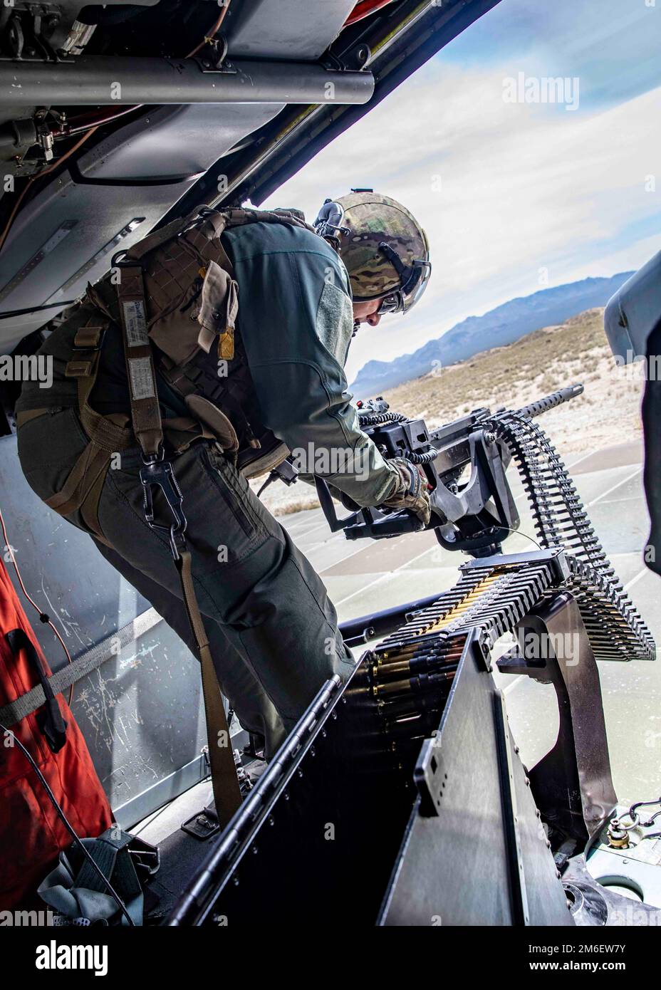 Senior Chief Naval Aircrewman (helicopter) Rabea Shaiboon flies during a gun exercise with Helicopter Sea Combat Squadron (HSC) 5 at Naval Air Station Fallon, April 26, 2022. Carrier Air Wing (CVW) 7 is the offensive air and strike component of Carrier Strike Group (CSG) 10 and the George H.W. Bush CSG. The squadrons of CVW-7 are Strike Fighter Squadron (VFA) 143; VFA-103; VFA-86; VFA-136; Electronic Attack Squadron (VAQ) 140; Carrier Airborne Early Warning Squadron (VAW) 121; HSC-5; and Helicopter Maritime Strike Squadron (HSM) 46. Stock Photo