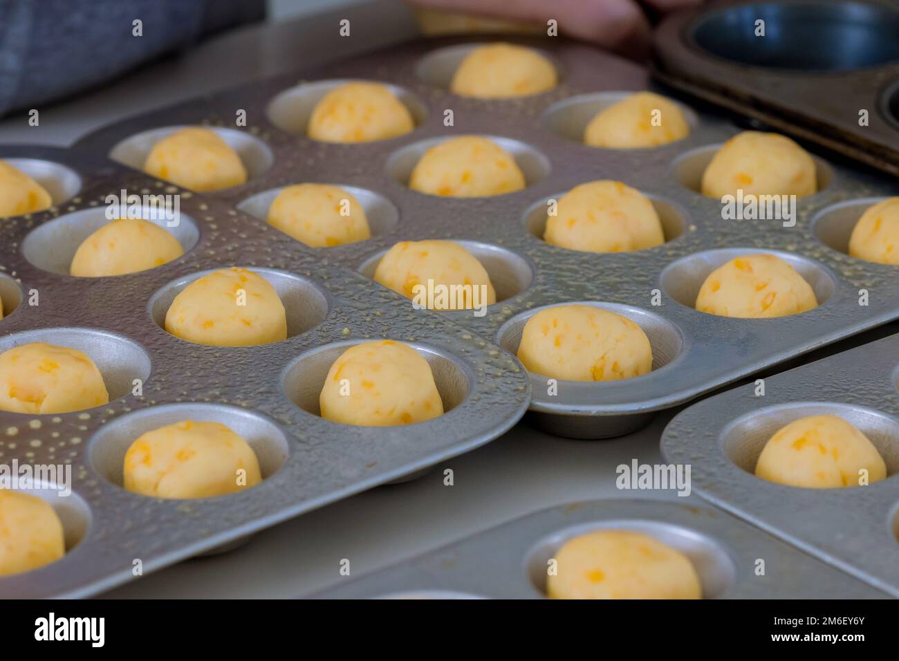Preparation and baking of Brazilian cheese buns traditionally used as snack are homemade Stock Photo