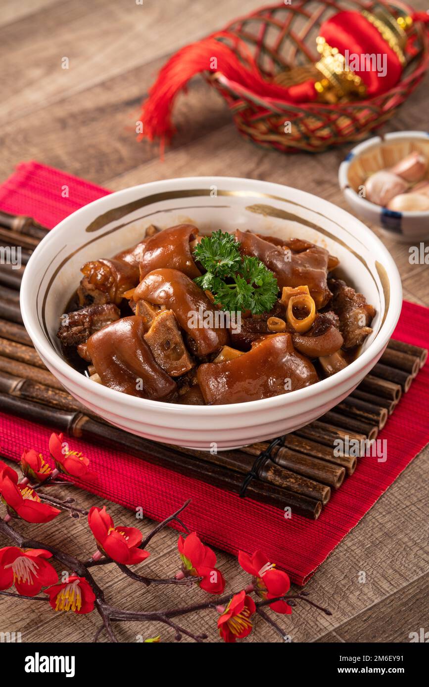 Taiwanese traditional food pork knuckle in a white bowl with golden