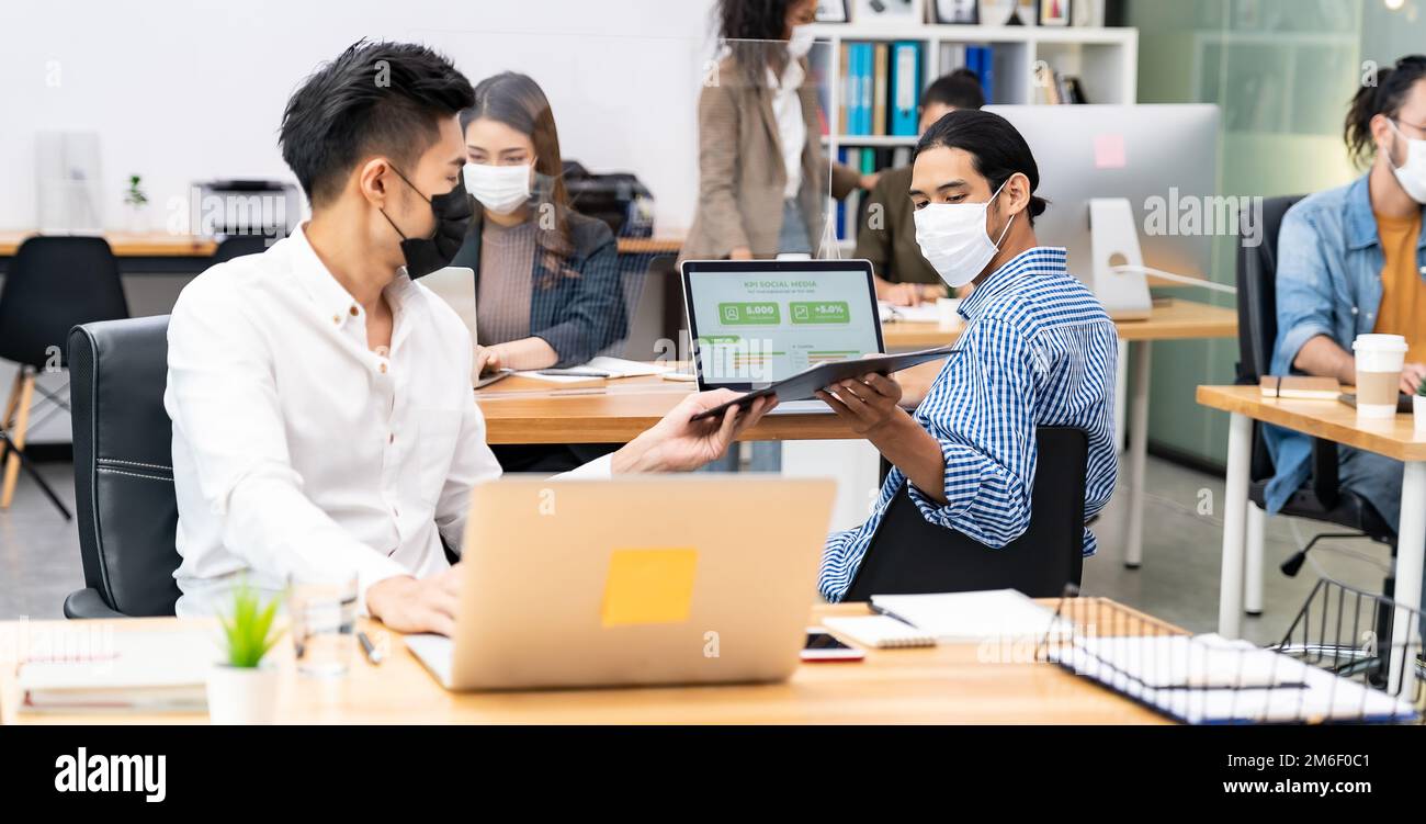 Panoramic Social distance office with business team wear face mask as ...