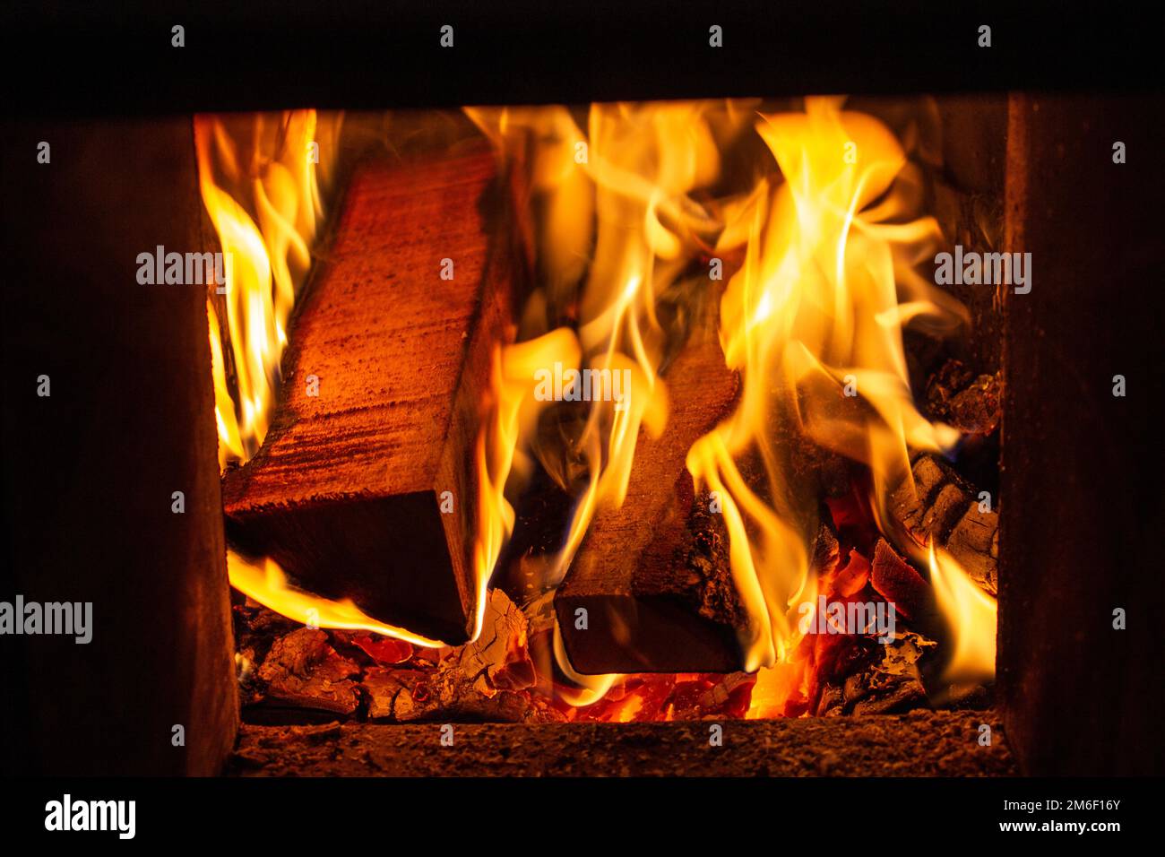 Wood burning in furnace in a home during winter. Stock Photo
