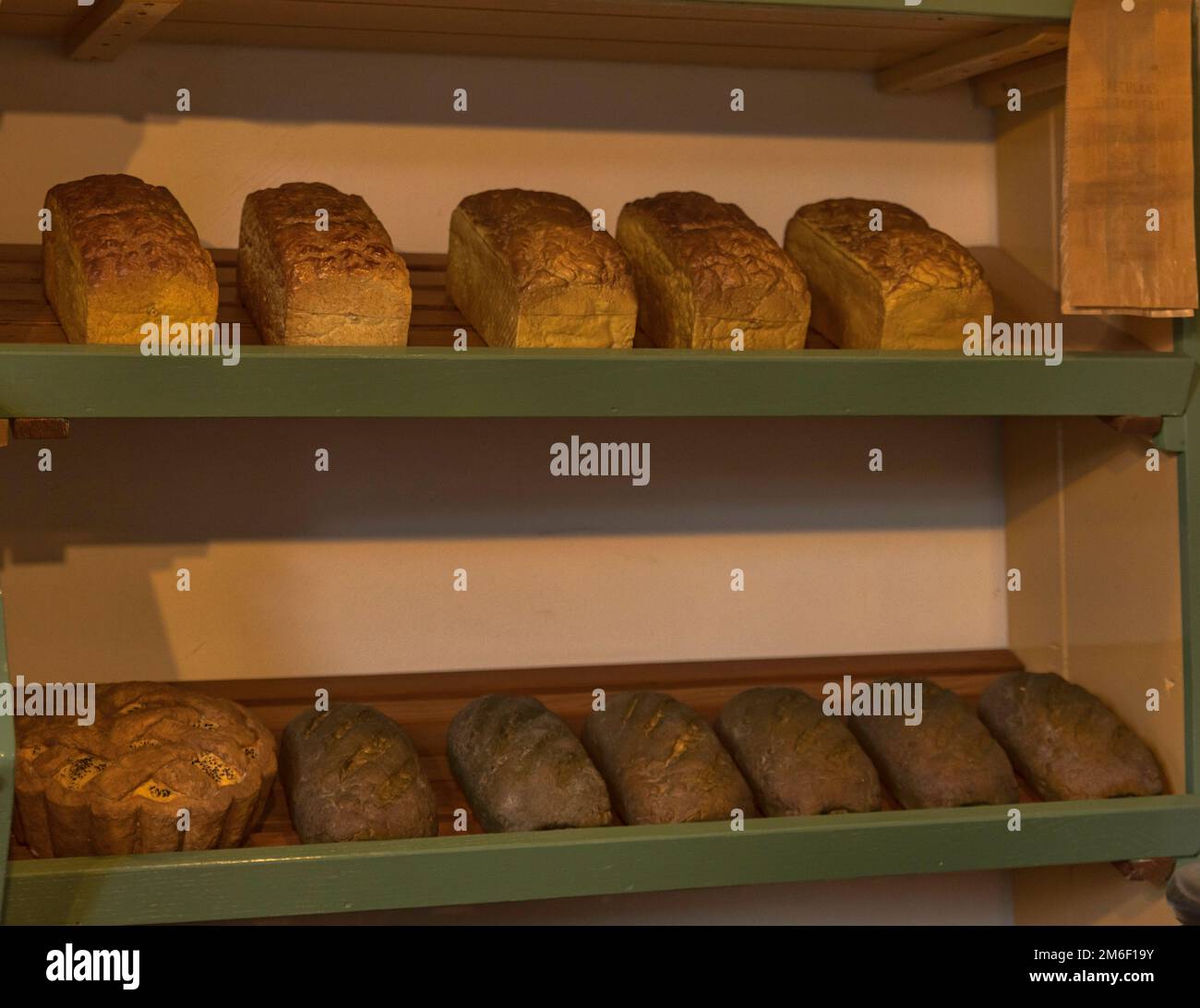 Shelf filled with loafs of bread in a bakery Stock Photo Alamy